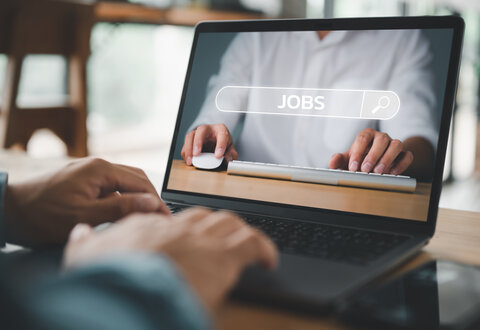 job search concept, man browsing work opportunities online using job search computer app. find your career, man looking at online website by laptop computer.